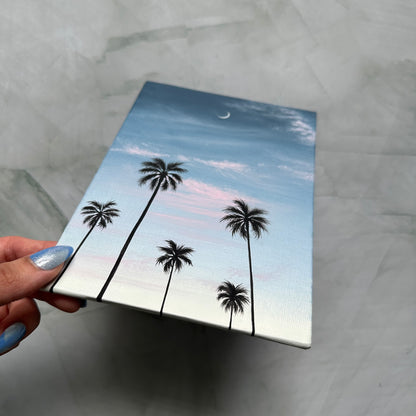crescent over palms