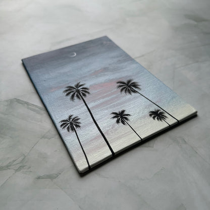 crescent over palms